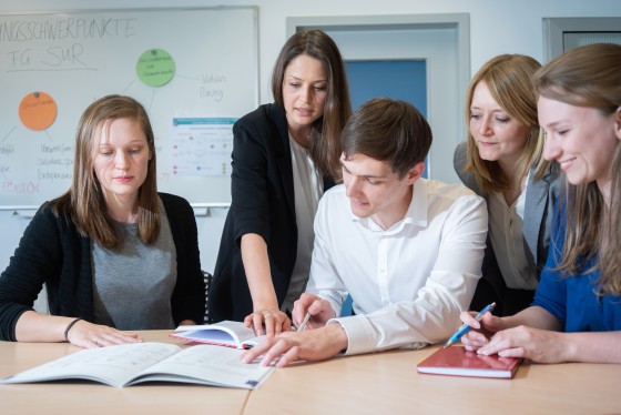 Studierende im Dialog an einem Tisch